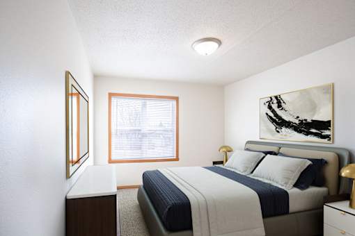 A bedroom with a bed, nightstand, and a painting on the wall. West Fargo, ND Sheyenne Terrace Townhomes