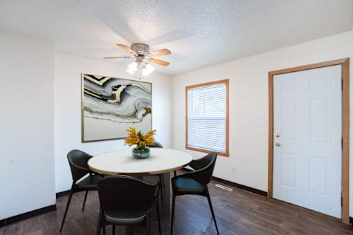 A dining room with a round table and chairs. West Fargo, ND Sheyenne Terrace Townhomes