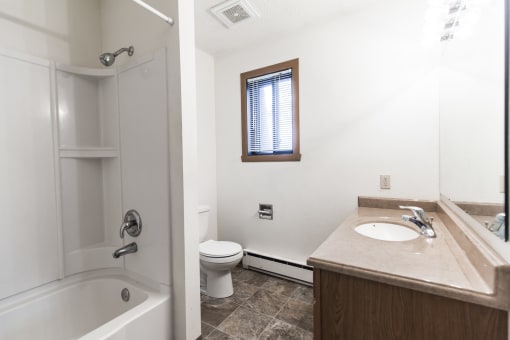 Bismarck, ND Arbor apartments. a bathroom with a toilet sink and bathtub