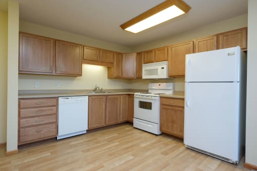 a kitchen with white appliances. Fargo, ND Crossroads Apartments