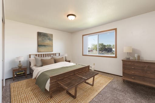 Bismarck, ND Brentwood II Apartments. A bedroom with a large bed and a large window