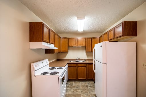 Bismarck, ND Eastbrook Apartments. A kitchen with a stove refrigerator and sink