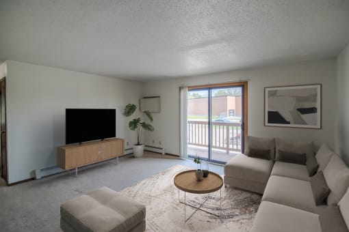 A living room with a couch and a coffee table. Bismarck, ND Eastbrook Apartments.