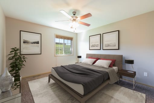 Bismarck, ND Stonefield Townhomes.The room features a comfortable bed, stylish furnishings, and a warm color palette, creating a relaxing atmosphere. The window fills the room with bright natural light.
