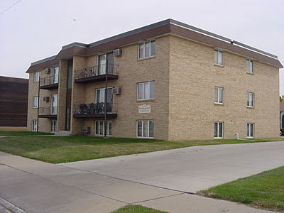 a large brick apartment building with balconies