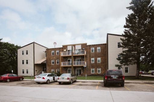 Grand Forks, ND Bristol Park Apartments.  A brick apartment building with cars parked in front of it