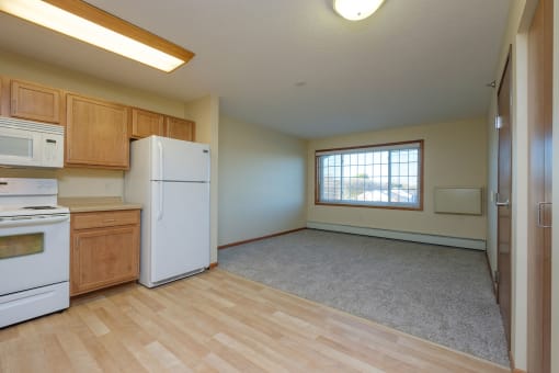 a living room with a window. Fargo, ND Crossroads Apartments