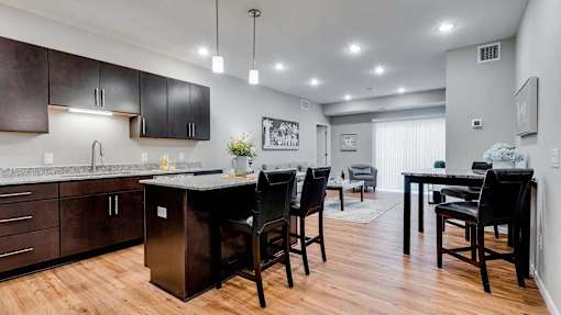 a kitchen and dining room with a table and chairs. Circle Pines, MN Lexington Lofts