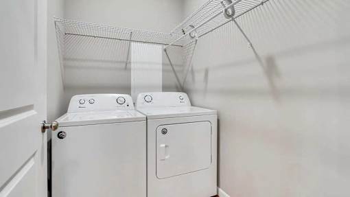 a washer and dryer in a laundry room with white walls. Circle Pines, MN Lexington Lofts