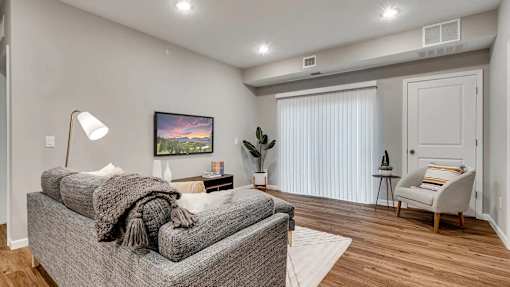 a living room with a couch and a chair. Circle Pines, MN Lexington Lofts