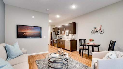 a living room and kitchen with a couch and a table. Circle Pines, MN Lexington Lofts