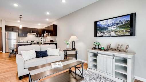 a living room and kitchen with a couch and a table. Circle Pines, MN Lexington Lofts