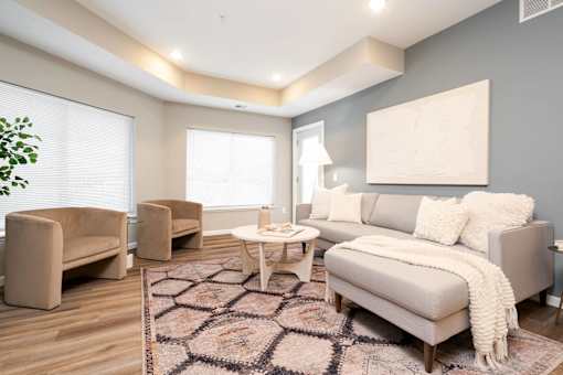 a living room with a couch and chairs. Circle Pines, MN Lexington Lofts