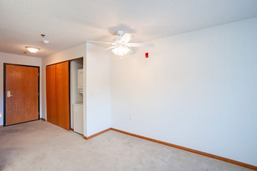 a empty room with a ceiling fan and a closet.  Eagan, MN Glen Pond Apartments