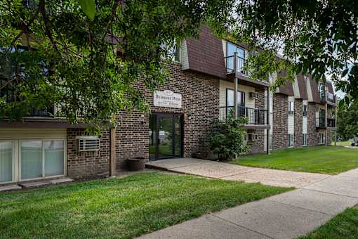 A brick building with a sign. Bismarck, ND Belmont West Apartments