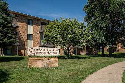 A brick building with a sign that says Garden Grove Apartments. Bismarck, ND Garden Grove Apartments