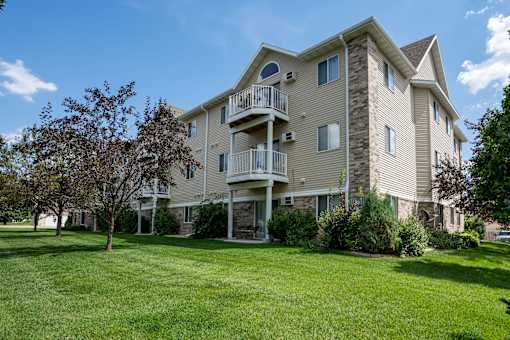 A large apartment building with a balcony on the second floor.