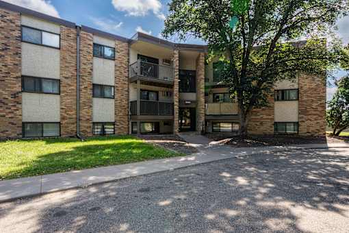 A large apartment complex with a tree in front. White Bear Lake, MN White Bear Terrace Apartments