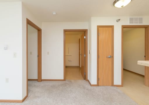 a hallway with doors to bedrooms and bathrooms with a closet. Fargo, ND Sunrise North