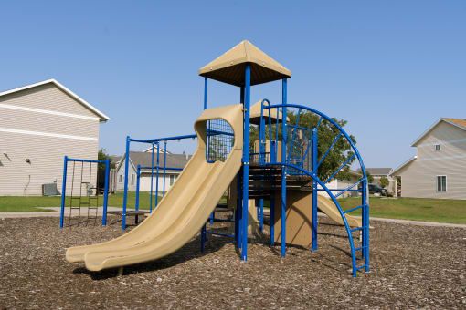 a playground with a slide and a tower. Fargo, ND Bluestem Townhomes