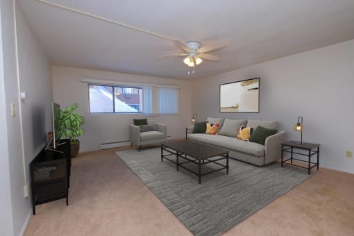 a living room with a couch and a coffee table. Fargo, ND North Manor Apartments