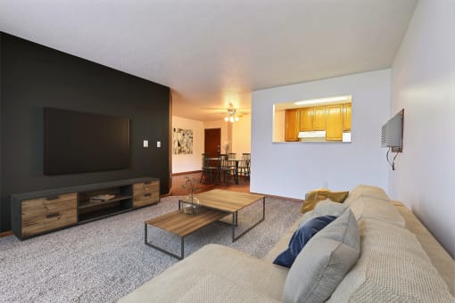Fargo, ND Oxford Apartments. a living room with a couch and a coffee table