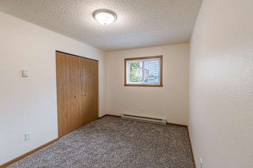 Fargo, ND Patricia Ann Apartments. A bedroom with a door and a window