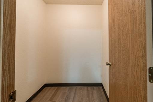 Fargo, ND Patricia Ann Apartments. A small room with a wooden door and hardwood floors