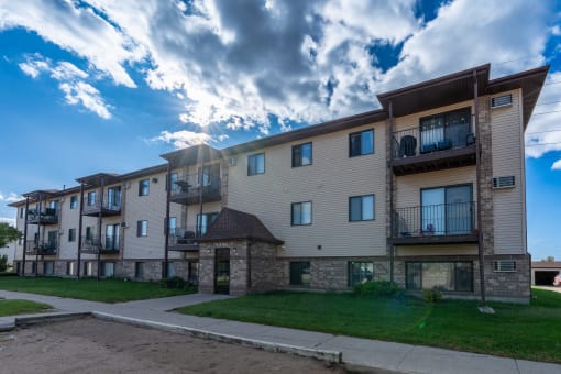 Fargo, ND Prairie Park Apartments. An apartment building with a cloudy sky in the background