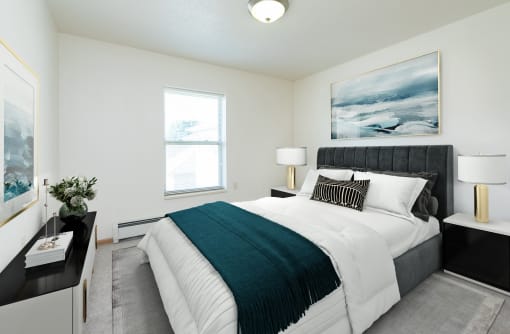 a bedroom with a large bed and a window. Fargo, ND Sunrise North