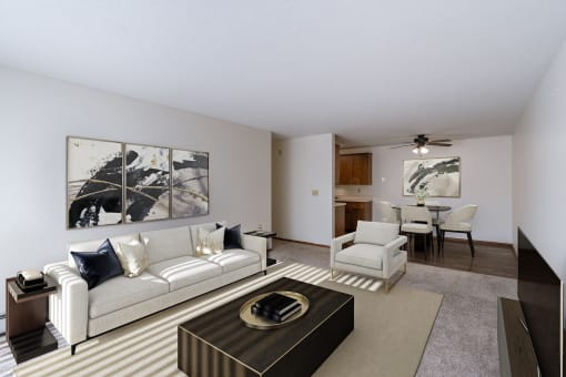a living room with a couch and a coffee table and a dining room. Fargo, ND Windsor Apartments