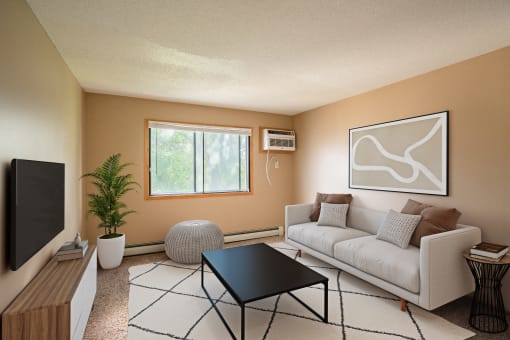 a living room with a white couch and a television. Fargo, ND Brookfield Apartments