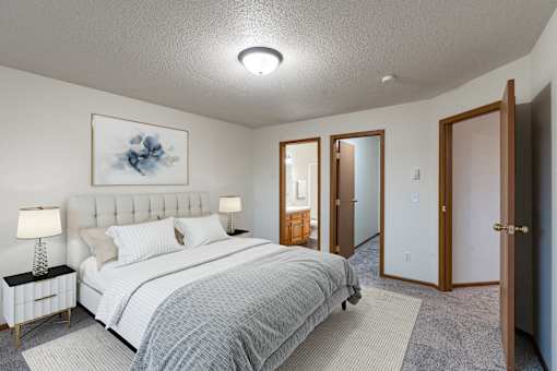 a bedroom with a bed and a closet. Fargo, ND Brownstone Apartments