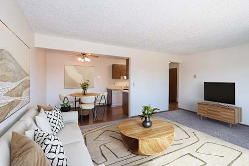 a living room with a couch and a table and a tv. Fargo, ND Hartford Apartments