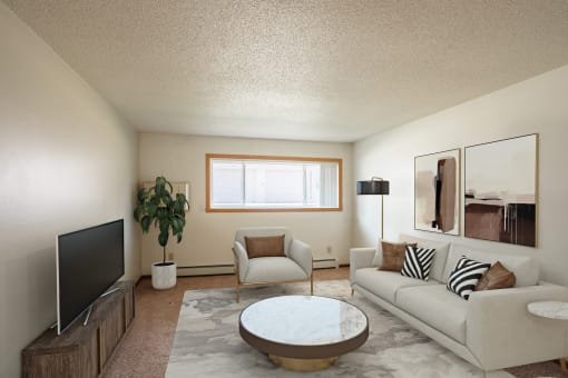 a living room with a couch and a coffee table and a tv. Fargo, ND Hawn Apartments