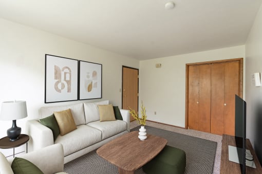 a living room with a couch and a coffee table. Fargo, ND Luxford Apartments