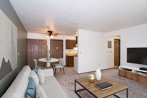 a living room with a couch and a coffee table. Fargo, ND Pacific Park 2 Apartments