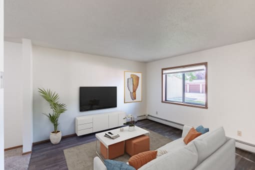 a living room with a white couch and a tv. Fargo, ND Rosegate Apartments