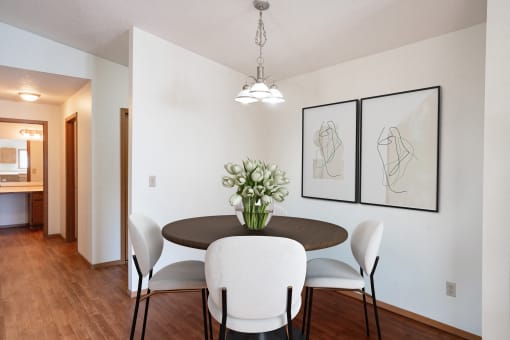 a dining room with a table and chairs. Fargo, ND Rosegate Apartments