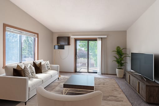 a living room with a couch and a coffee table and a tv. Fargo, ND Rosegate Apartments