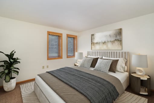 a bedroom with a bed, night stands, and two small windows. Golden Valley, MN Valley View Apartments | 11B | Bedroom