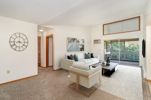 a furnished living room with high vaulted ceilings. Golden Valley, MN Valley View Apartments