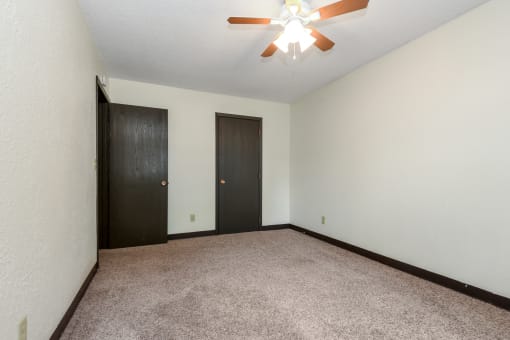 White Bear Lake, MN White Bear Terrace Apartments.  an empty room with a ceiling fan and two doors
