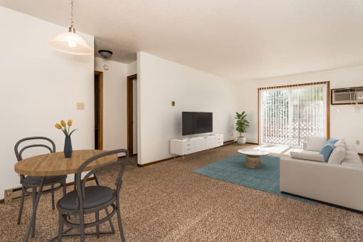Grand Forks, ND Washington Apartments a living room with a table and chairs and a television on the wall