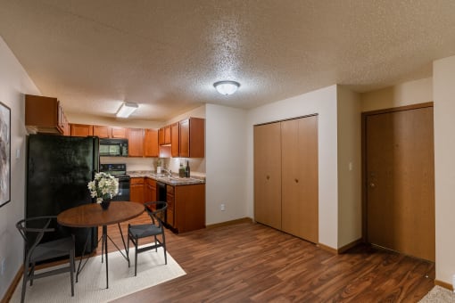 the view of a living room and kitchen with a table and chairs