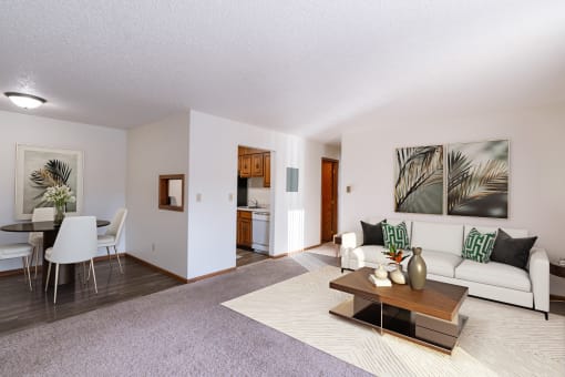 a living room and dining room with a couch and a table. Grand Forks, ND Cedarwood Apartments