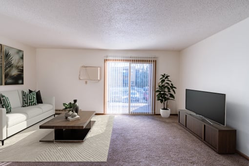 a living room with a couch and a coffee table and a television. Grand Forks, ND Cedarwood Apartments