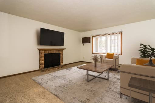 Grand Forks, ND Columbia West Apartments a living room with a fireplace and a tv