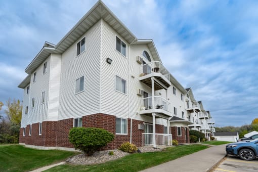 Grand Forks, ND Creekside Apartments. A white apartment building with a sidewalk in front of it