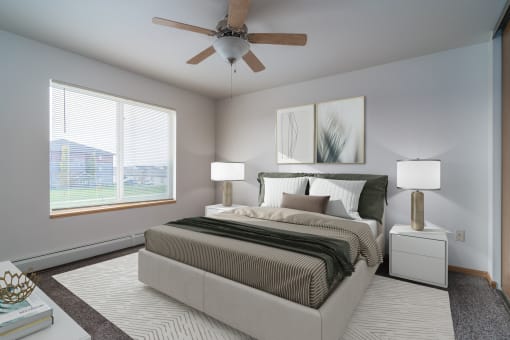 a spacious bedroom with a ceiling fan and a bed. Grand Forks Desoto Estates